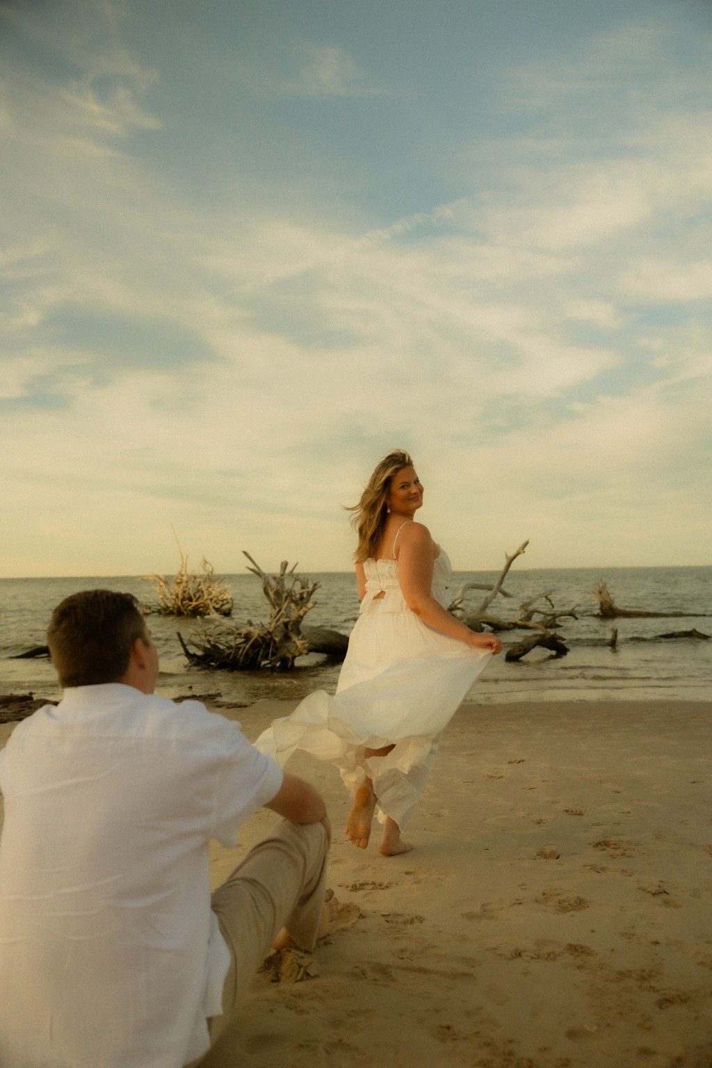 Tori walking on the beach while Drake watches